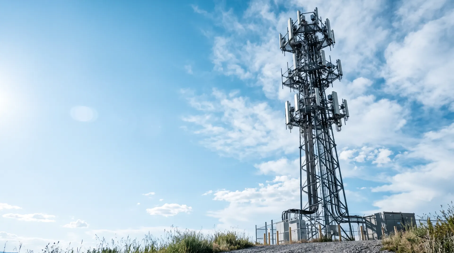 Torre de telecomunicaciones de fibra y móvil bajo un cielo azul despejado